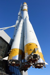 Three-stage space rocket against a blue sky
