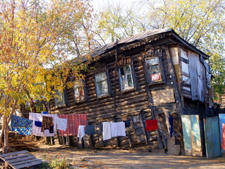 An old village house against a blue sky in autumn
