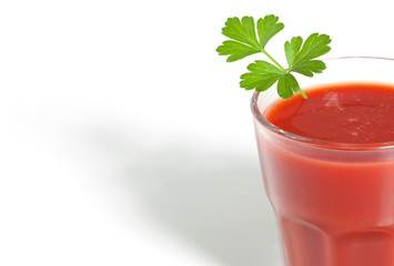 Tomato juice in clear glass isolated on white background.