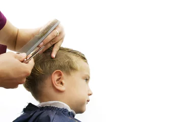 Papier Peint photo Lavable Salon de coiffure child getting haircut isolated over white