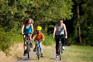 Family riding bicycles for sport (focus on son)