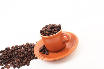 cup and coffee beans isolated over white background