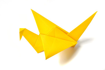 Yellow origami crane over white