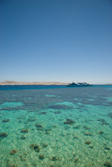 Fototapeta premium Tropical lagoon woth boats on the horizon