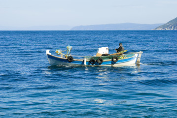 Priest in a fishing boat going for fishing