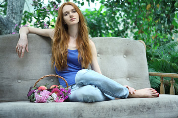 Romantic garden girl at summer with beautiful basket of flowers