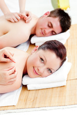 Obraz na płótnie Canvas Bright caucasian couple receiving a back massage