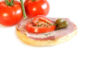 Brötchen mit kaltem Braten, Oliven u. Tomate