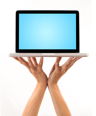 a male hand holding a laptop