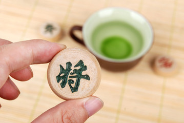 tea with chinese chess on bamboo tray