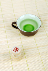 tea with chinese chess on bamboo tray