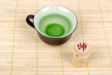 tea with chinese chess on bamboo tray
