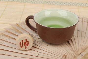 tea,chinese fan with chess on bamboo tray