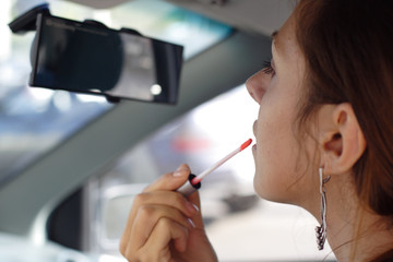 Beautiful Woman do put on make-up in car