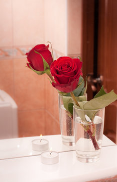 Rose with candle on mirror shelf