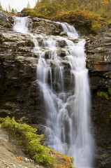 Fototapeta na wymiar Falls among the northern mountains