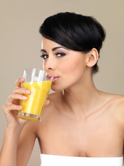 Portrait of beautiful woman, she holding glass of orange juice