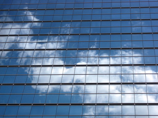 Glass wall with the reflection of sky