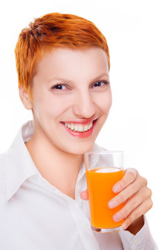 Beautiful smiling woman drinks orange juice