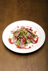 Meat with salad served on the white round  plate