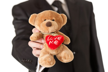Man in suit  holding teddy bear on white isolated background