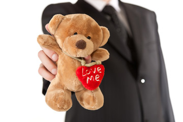 Man in suit  holding teddy bear on white isolated background