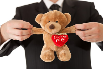 Man in suit  holding teddy bear on white isolated background