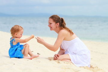 Loving mother and daughter on tropical beach