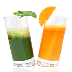 fresh juices from carrot and parsley in glasses isolated