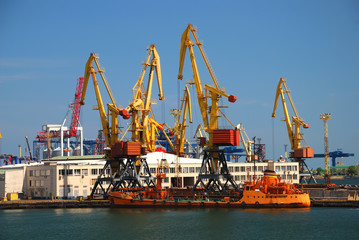 The trading seaport with cranes, cargoes and ship