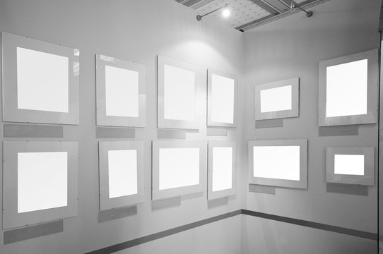 Blank white picture frames in art gallery