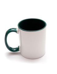White mug with green handle