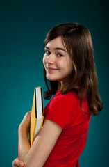 Girl holding book on blue background