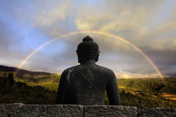 Buddha coverend under a full rainbow