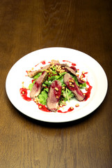 Meat with salad served on the white round  plate
