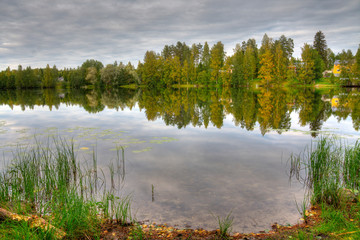 HDR photo of finnish scenery, with lake and forest and foregroun