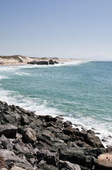 Ocean view with rocks, dunes and old blockhouses on the beach