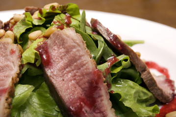 Meat with salad served on the white round  plate