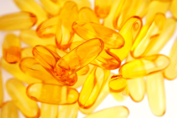Closeup of yellow gel fish oil capsules
