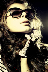 Fashion portrait of a l young sexy woman wearing sunglasses