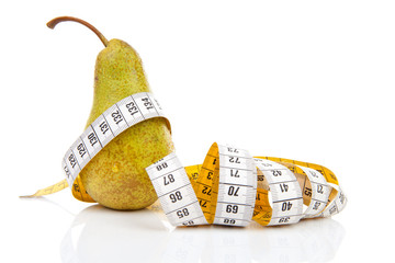 Pear with measure tape over white background