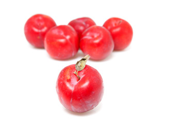 couple of red plums over white background
