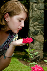 Teenage Girl Smelling a Rose