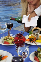 Waiter serving wine in a gourmet restaurant.