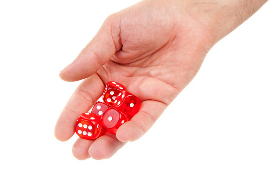 hand is throwing red dices over white background