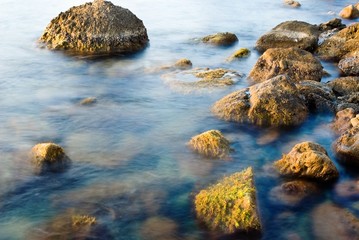 beautiful stones in a sea at the evening
