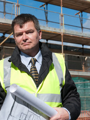 Smiling, confident architect looks at camera