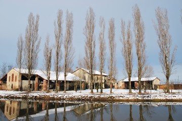 Fototapeta na wymiar Country house and river in winter, Po valley, Italy