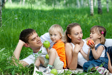 Happy family in park having picnic