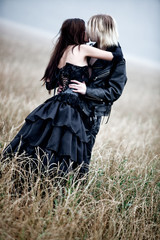 Young goth couple kissing outdoors